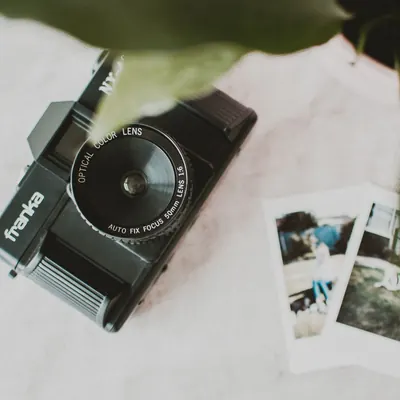 A film camera resting on a white cloth